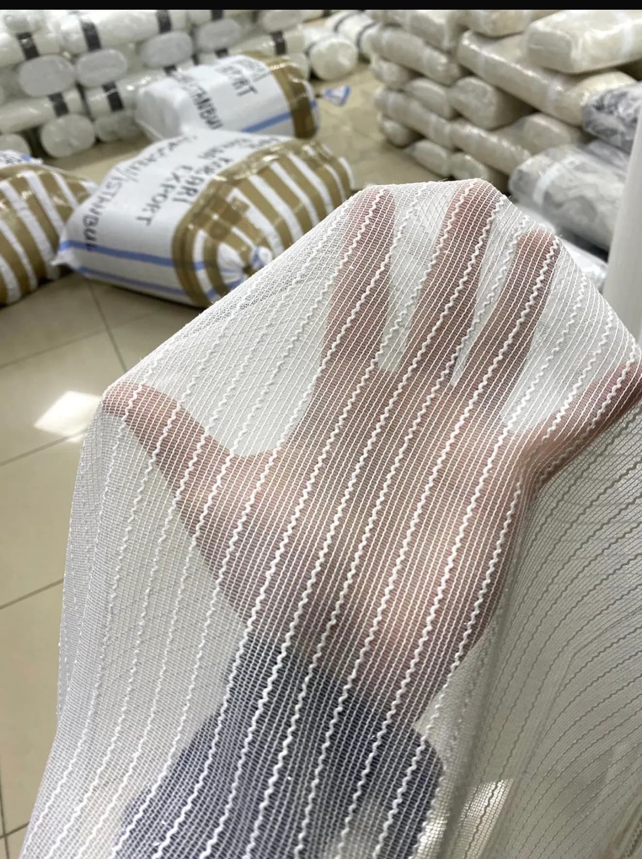Measuring a window with fabric swatches laid out